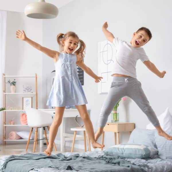 Kids jumping in bed